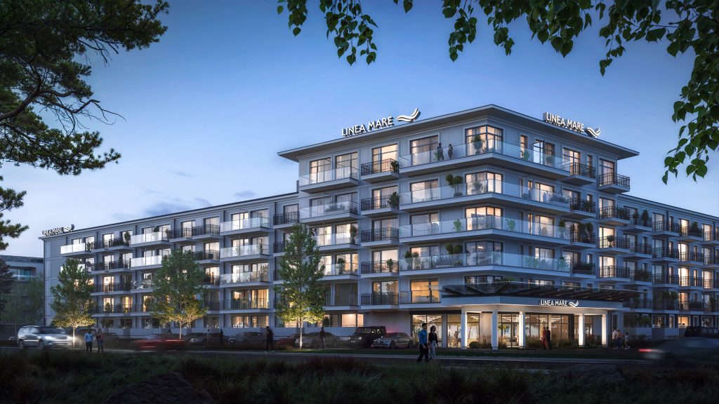 Nowoczesny budynek Linea Mare Kołobrzeg o zmierzchu z podświetloną elewacją, balkonami i wejściem głównym.