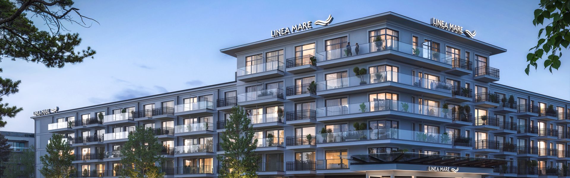Nowoczesny budynek Linea Mare Kołobrzeg o zmierzchu z podświetloną elewacją, balkonami i wejściem głównym.
